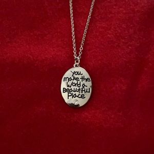 Silver necklace with charm.